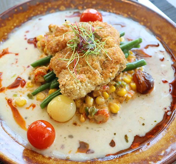 ANR Grouper Almondine over crawfish maque choux with green beans and blistered tomatoes