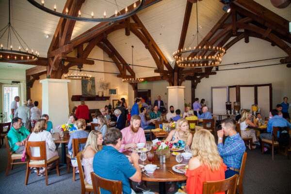 Watersound Club members enjoying dinner and each others' company at a member event in the dining room at Shark's Tooth Golf Club