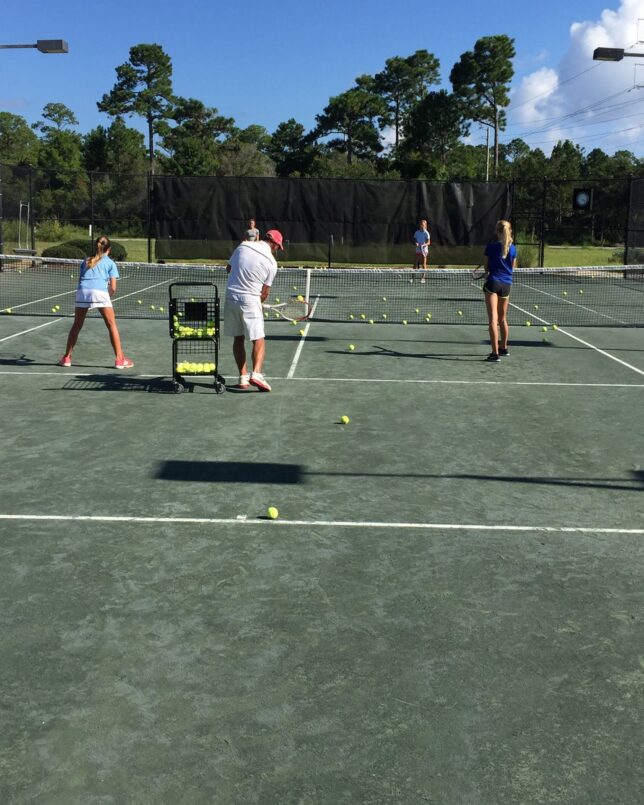 Watersound Club members enjoying a ladies tennis lesson from Director of Tennis, Barry Webb, at Shark's Tooth