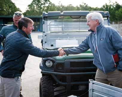 Patrick Murphy of St. Joe and an executive of Love Golf shake hands